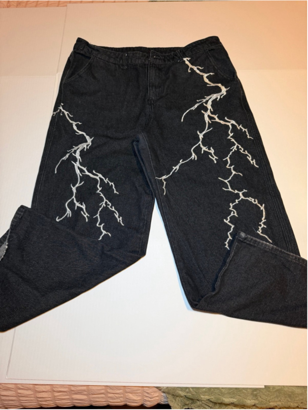 baggy wide-leg denim jeans with a white lightning bolt design on leg Y2K no snap